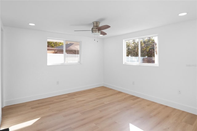 unfurnished room with light hardwood / wood-style flooring, plenty of natural light, and ceiling fan