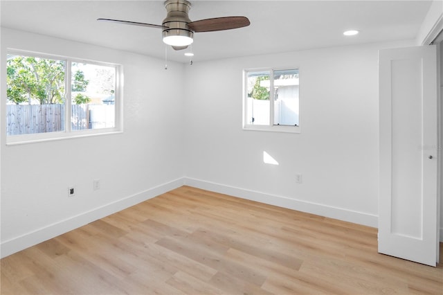 empty room featuring ceiling fan and light hardwood / wood-style flooring