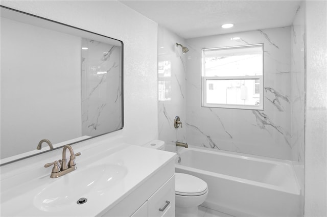 full bathroom featuring tiled shower / bath, vanity, toilet, and a textured ceiling