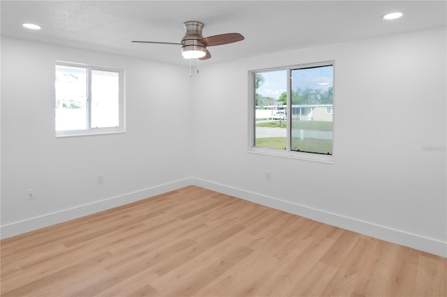 empty room with ceiling fan and light wood-type flooring