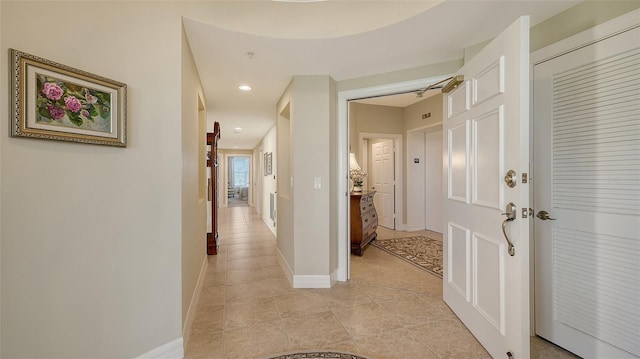 hallway featuring light tile patterned floors