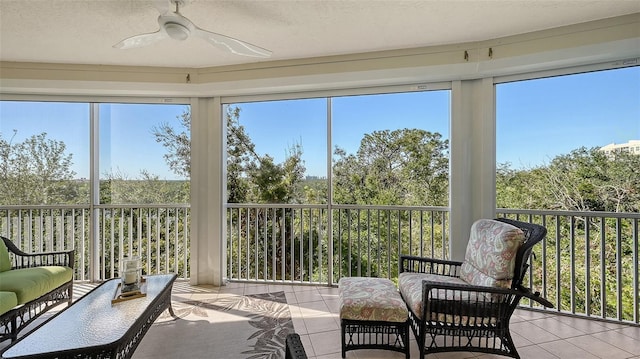 sunroom / solarium featuring ceiling fan