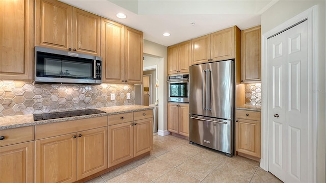 kitchen with light tile patterned flooring, light brown cabinetry, backsplash, stainless steel appliances, and light stone countertops