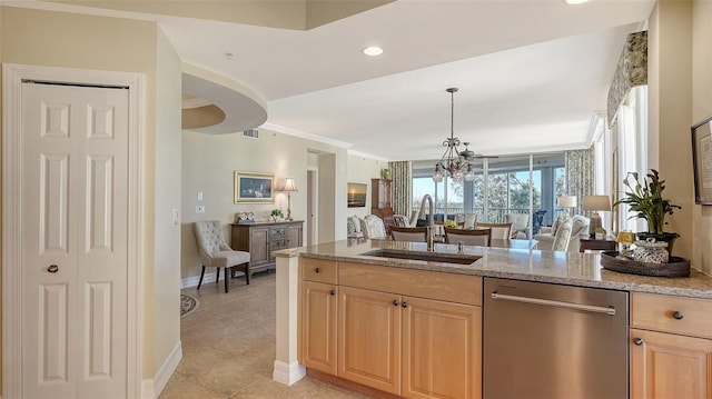 kitchen with sink, light brown cabinets, light tile patterned floors, stainless steel dishwasher, and ornamental molding