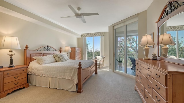 carpeted bedroom featuring access to outside and ceiling fan