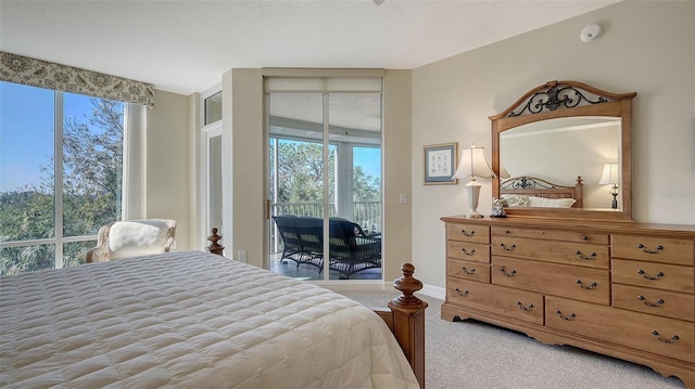 carpeted bedroom with multiple windows and access to outside