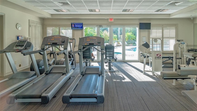 exercise room featuring a drop ceiling and plenty of natural light