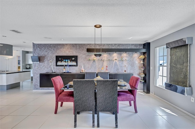 tiled dining area with a textured ceiling