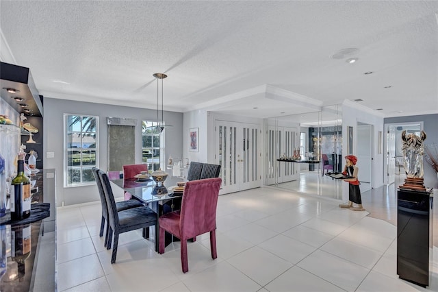 tiled dining space featuring crown molding and a textured ceiling