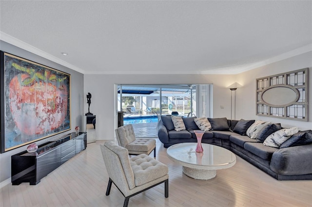 living room with crown molding, light hardwood / wood-style flooring, and a textured ceiling