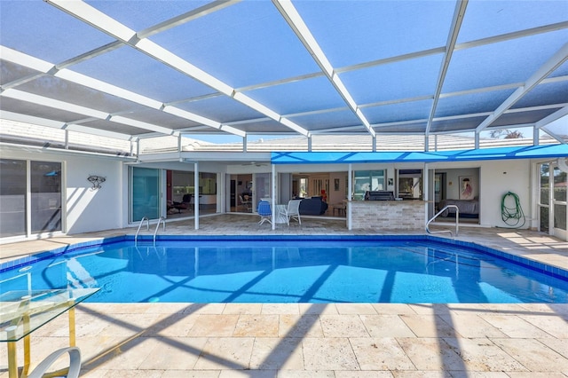 view of swimming pool with a lanai and a patio