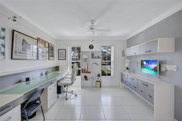 office featuring light tile patterned flooring, ornamental molding, built in desk, and a textured ceiling