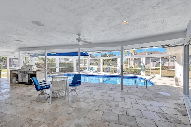 view of pool featuring grilling area, glass enclosure, and a patio area