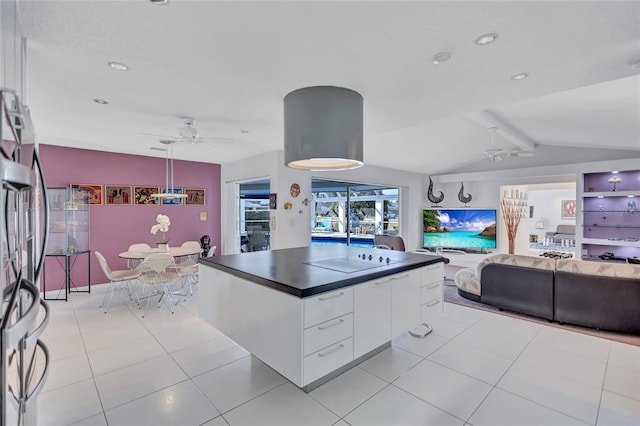 kitchen with black electric cooktop, ceiling fan, lofted ceiling with beams, and white cabinets