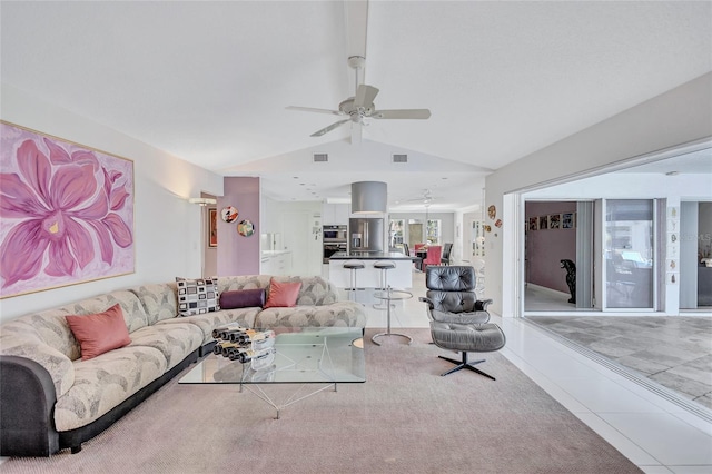 tiled living room with lofted ceiling and ceiling fan