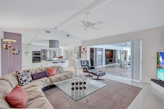 living room with light tile patterned floors, lofted ceiling with beams, and ceiling fan