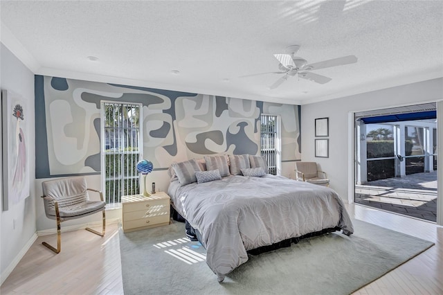 bedroom featuring ornamental molding, access to exterior, ceiling fan, a textured ceiling, and light hardwood / wood-style flooring