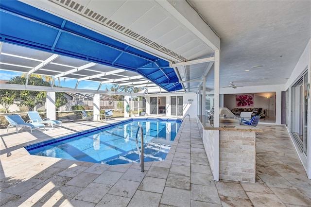 view of swimming pool with a bar, area for grilling, and a patio