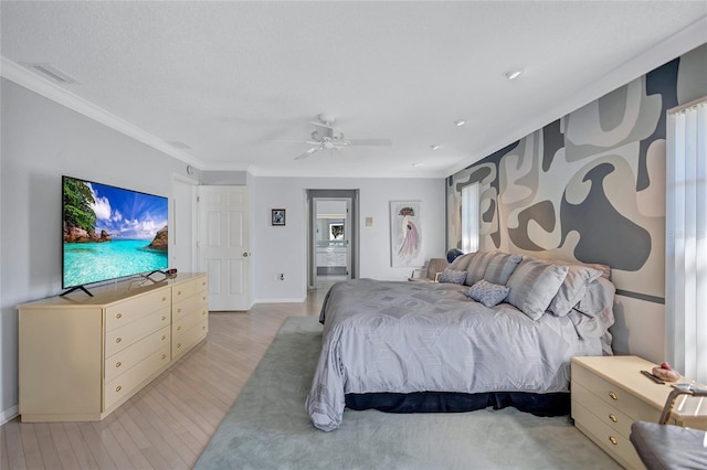 bedroom featuring ceiling fan, ornamental molding, and light hardwood / wood-style floors