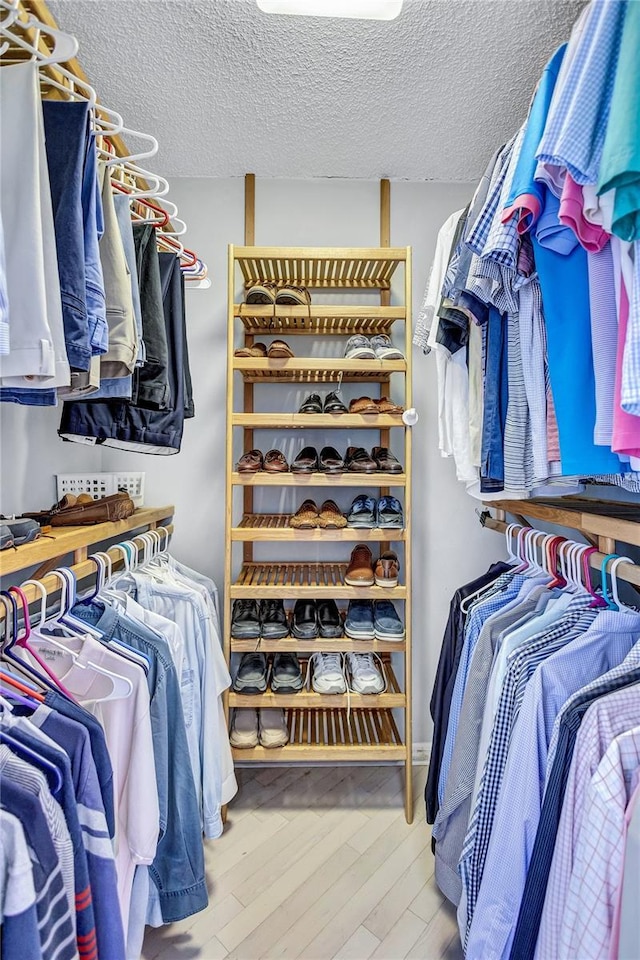 spacious closet featuring hardwood / wood-style flooring