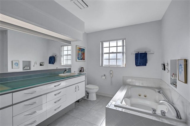 bathroom with tile patterned flooring, a wealth of natural light, tiled bath, and toilet