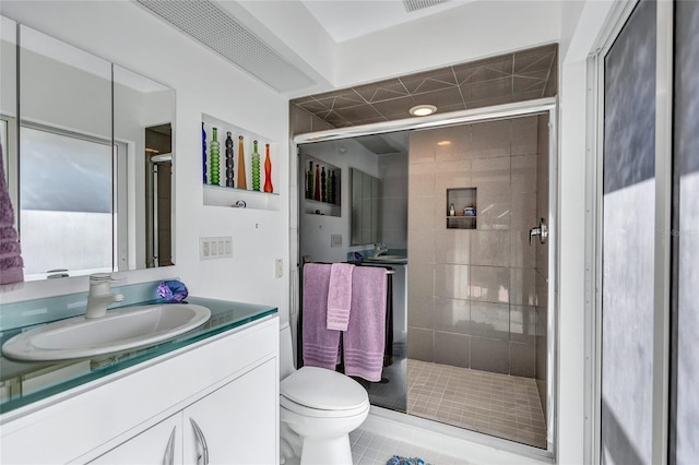 bathroom with vanity, toilet, and walk in shower