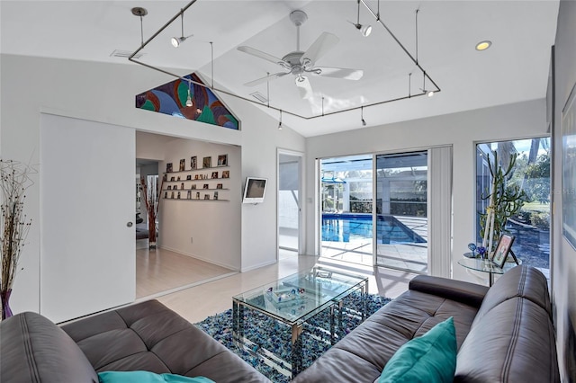 living room featuring ceiling fan and lofted ceiling