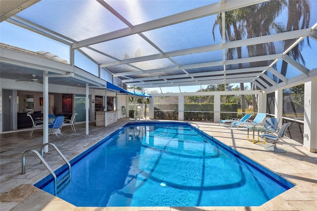 view of pool featuring ceiling fan, a patio area, and glass enclosure