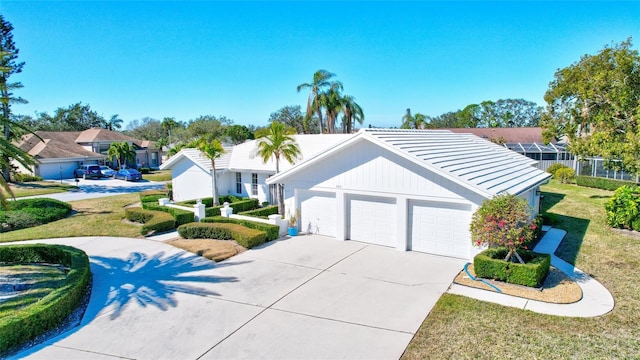 view of front of property with a garage and a front lawn