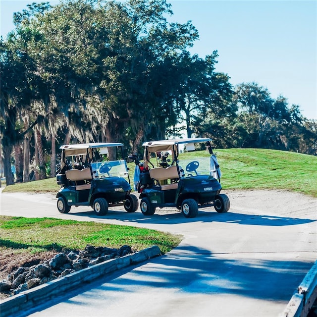 view of parking with a yard