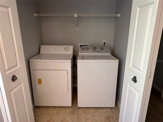 laundry area featuring separate washer and dryer and light tile patterned flooring