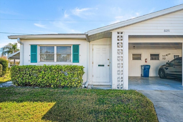 doorway to property featuring a garage and a yard