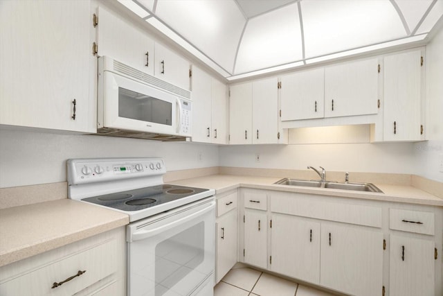 kitchen featuring light tile patterned flooring, white appliances, sink, and white cabinets