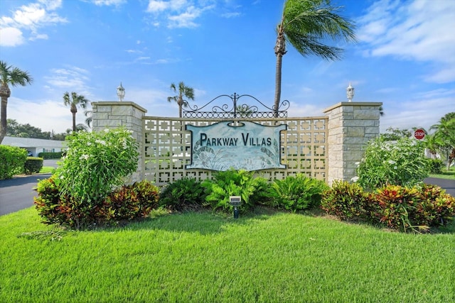 community sign featuring a lawn