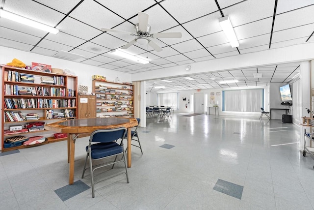 home office featuring a paneled ceiling and ceiling fan