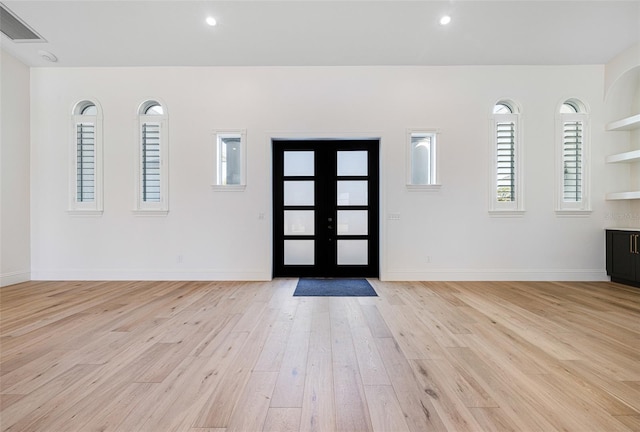 entrance foyer featuring light wood-type flooring and french doors