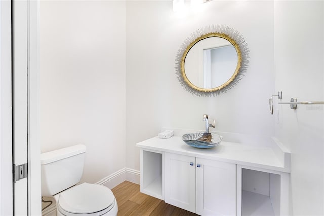 bathroom with vanity, hardwood / wood-style floors, and toilet