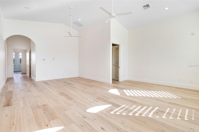 unfurnished room with high vaulted ceiling, light hardwood / wood-style floors, and ceiling fan