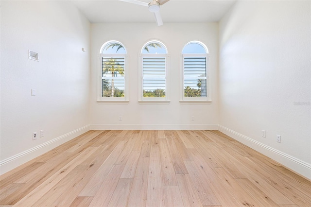 empty room with ceiling fan and light hardwood / wood-style floors