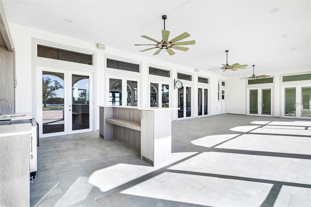 view of patio featuring sink, ceiling fan, and french doors