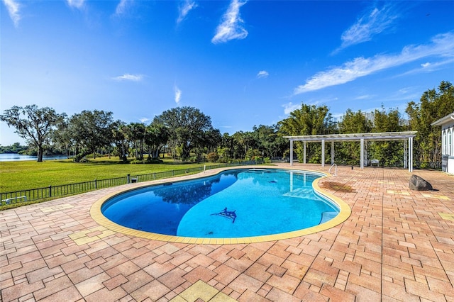 view of swimming pool featuring a water view, a pergola, a patio, and a lawn