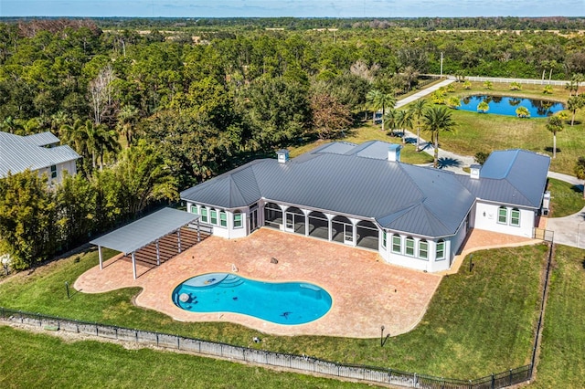 view of pool featuring a yard, a patio area, and a sunroom