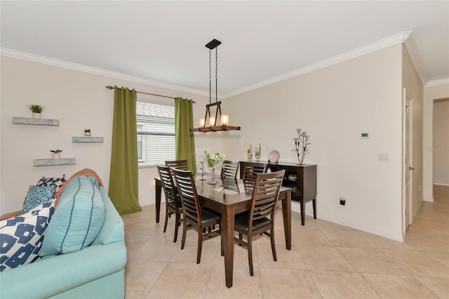 tiled dining space featuring ornamental molding and a chandelier