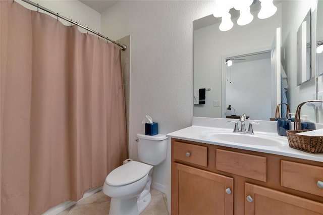 bathroom featuring vanity, tile patterned floors, and toilet