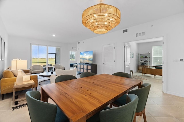 dining area featuring a notable chandelier and light tile patterned floors