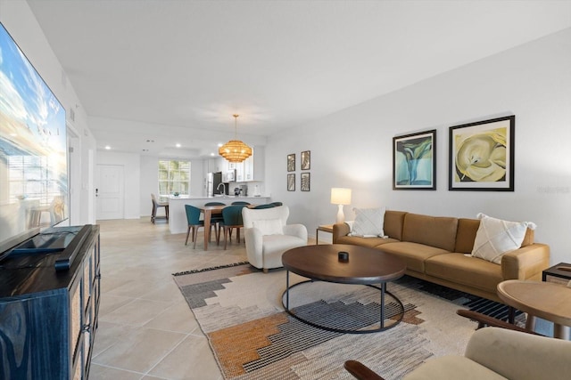 living room featuring a notable chandelier and light tile patterned floors