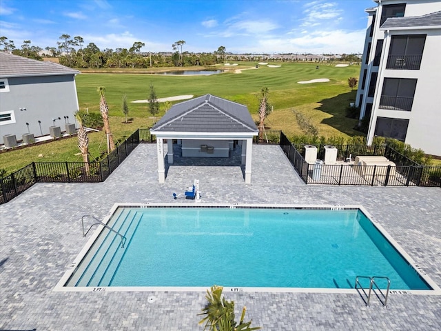 view of pool with a gazebo, a lawn, a patio, and an outbuilding