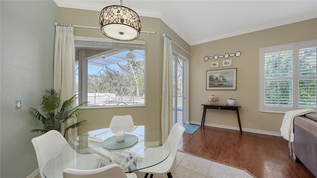 12471 Natureview Cir, Bradenton, FL 34212 - dining room featuring plenty of natural light, ornamental molding, wood finished floors, and baseboards