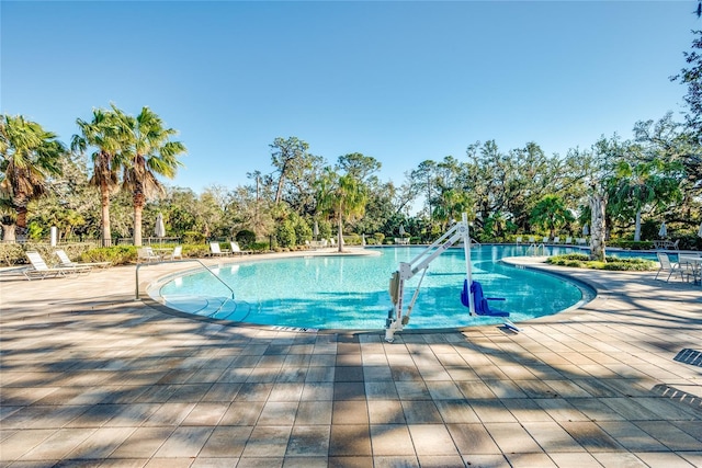 view of swimming pool featuring a patio area