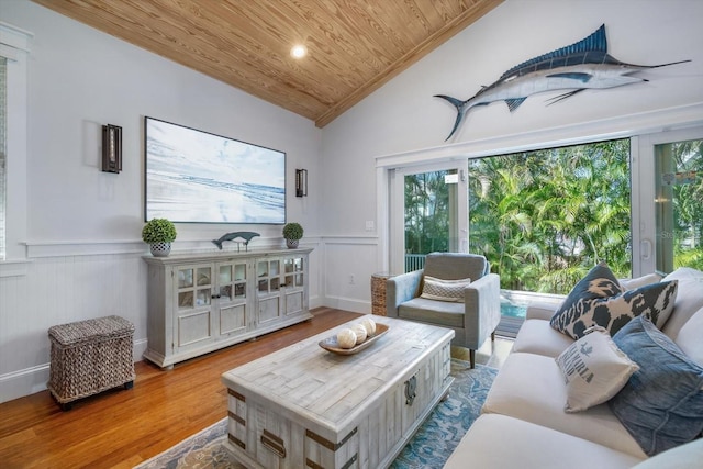 living room with vaulted ceiling, wood ceiling, and light hardwood / wood-style floors